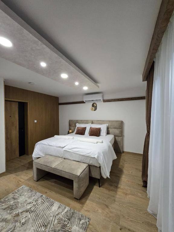 Modern bedroom with wooden panelling and bench