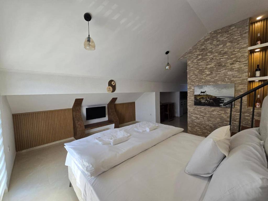 Spacious attic room with double bed at Hotel Mažijanik